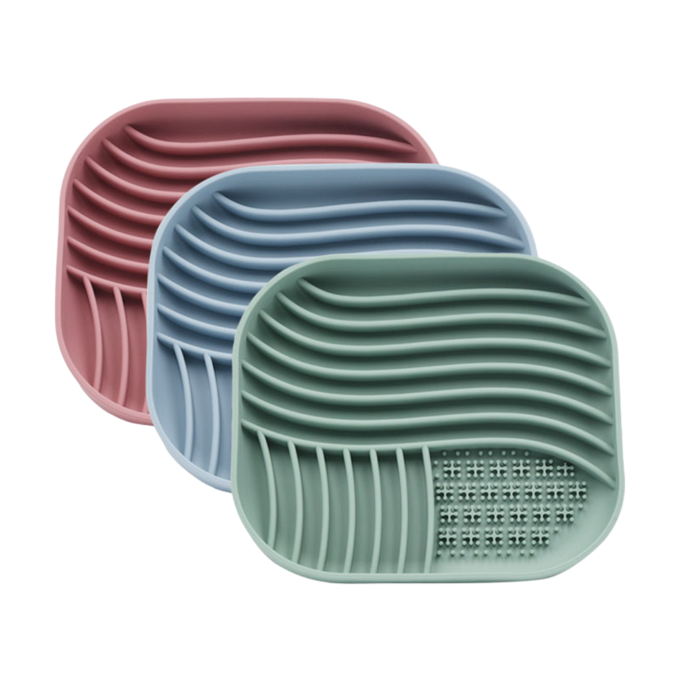 Three silicone licking mats for pets in pink, blue, and green.